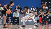 Latrell Allmond defends during the John Marshall game against Woodside at the 13th Annual Coaches for the Cure High School Basketball Showcase, where he scored 17 points and hit the game-winning shot in the final seconds, leading the Justices to a 50-47 victory.