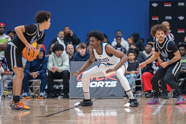 Latrell Allmond defends during the John Marshall game against Woodside at the 13th Annual Coaches for the Cure High School Basketball Showcase, where he scored 17 points and hit the game-winning shot in the final seconds, leading the Justices to a 50-47 victory.