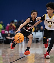 Team Loaded Foundation’s fourth grade 10U Youth Travel League plays in a short scrimmage against Gates during halftime of the final game of the Coaches for the Cure Basketball Showcase. Many of the players from the John Marshall High School Basketball Team, which competed in the showcase, started in this league.