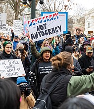 Hundreds of protestors on Capitol Square listen as Lyn Jones, 16, speaks to the crowd at the Bell Tower on Wednesday, Feb. 5. Jones helped organize the demonstration as part of the nationwide “50 Protests, 50 States, 1 Day” movement, protesting the policies of President Donald Trump’s administration.