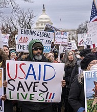 Demonstrators and lawmakers rally against President Donald Trump and his ally Elon Musk as they disrupt the federal government, including dismantling the U.S. Agency for International Development, which administers foreign aid approved by Congress, on Capitol Hill in Washington, Wednesday, Feb. 5, 2025.