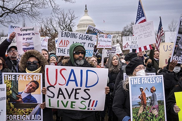 Demonstrators and lawmakers rally against President Donald Trump and his ally Elon Musk as they disrupt the federal government, including dismantling the U.S. Agency for International Development, which administers foreign aid approved by Congress, on Capitol Hill in Washington, Wednesday, Feb. 5, 2025.
