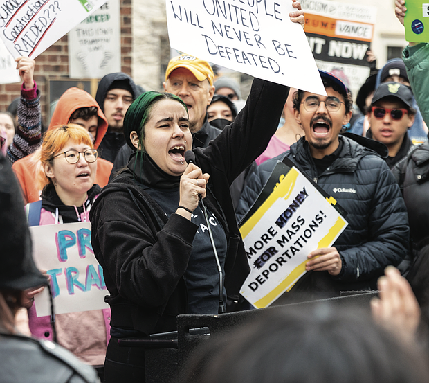 Christina Collazo, with the RVA Women’s March group, speaks to a crowd of hundreds of protestors as part of the nationwide “50 Protests, 50 States, 1 Day” event at the Bell Tower in Capitol Square on Wednesday, Feb. 5.