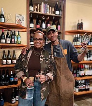 Penny’s Wine Shop owners Kristen Gardner Beal and Lance Lemon stand among their carefully curated selection of natural wines in their Brook Road shop. Their online wine membership program, RichWine, is featured in a Google ad airing during the Super Bowl in the Richmond market.