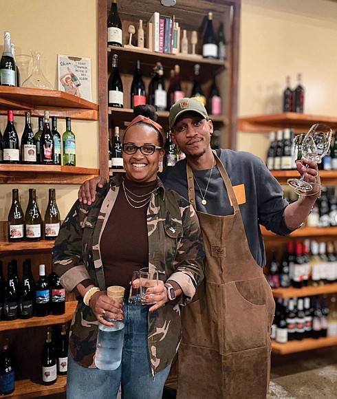 Penny’s Wine Shop owners Kristen Gardner Beal and Lance Lemon stand among their carefully curated selection of natural wines in their Brook Road shop. Their online wine membership program, RichWine, is featured in a Google ad airing during the Super Bowl in the Richmond market.