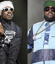 This combination of photos shows André 3000, left, and Big Boi of Outkast performing at Lollapalooza in Chicago’s Grant Park on Aug. 2, 2014.