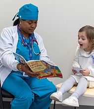 Fortis College dental assistant student J’neeka Woodson reads to 3-year-old Charlotte while she waits to get her teeth cleaned during the the American Dental Association Foundation’s
Give Kids A Smile program Thursday, Feb. 6, at the Fortis College campus in Richmond.