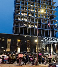 Dozens of demonstrators gather on Broad Street outside Richmond City Hall on Feb. 5, chanting “Trans rights now” in support of continued access to transgender health care for minors amid recent policies enacted by President Trump’s administration.