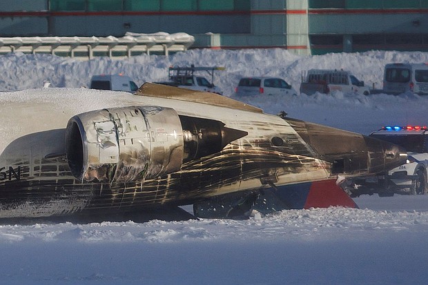 Emergency responders work after a plane crash at Toronto Pearson International Airport in Mississauga, Ontario, Monday.
Mandatory Credit:	Cole Burston/Reuters via CNN Newsource