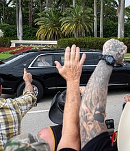 President Donald Trump waves to supporters as he leaves the Trump International Golf Club on February 17 in West Palm Beach, Florida.
Mandatory Credit:	Ben Curtis/AP via CNN Newsource