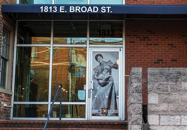 Image of Sister Rosetta Tharpe, Rock and Roll Hall of Fame member and former Barton Heights
resident, in the window of Shockoe Media. The photo is one of 20 large-scale historic images
displayed in windows throughout Shockoe Bottom as part of the public art project “Portals,”
which celebrates the legacy, resilience and everyday lives of Black Richmonders from the early
1800s to the 1980s.