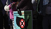 A community member holds a sign calling for a national boycott of Target stores during a news conference Jan. 30 outside Target Corporation’s headquarters in Minneapolis.