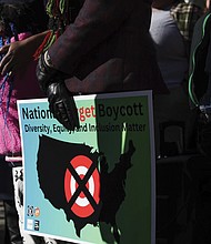 A community member holds a sign calling for a national boycott of Target stores during a news conference Jan. 30 outside Target Corporation’s headquarters in Minneapolis.