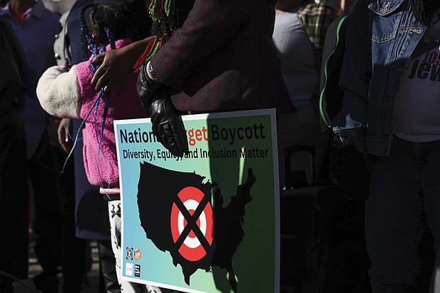 A community member holds a sign calling for a national boycott of Target stores during a news conference Jan. 30 outside Target Corporation’s headquarters in Minneapolis.