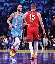 Team Shaq’s Stephen Curry and James Harden react to a Curry 3-pointer Feb. 16 against Team Chuck in the championship game of the 74th NBA All-Star Game in San Francisco.
