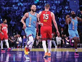 Team Shaq’s Stephen Curry and James Harden react to a Curry 3-pointer Feb. 16 against Team Chuck in the championship game of the 74th NBA All-Star Game in San Francisco.