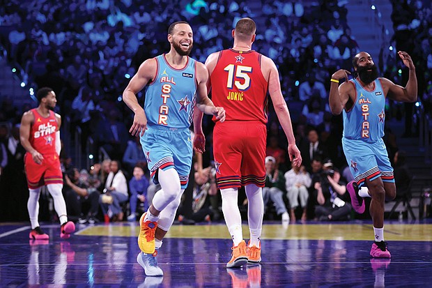 Team Shaq’s Stephen Curry and James Harden react to a Curry 3-pointer Feb. 16 against Team Chuck in the championship game of the 74th NBA All-Star Game in San Francisco.