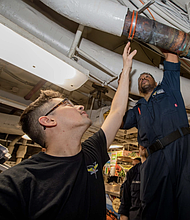 Fireman Grant Dailey, left, of Tomball, Texas, and Machinist Mate 1st Class Michael Ester, of Chicago, PHILIPPINE SEA
02.14.2025
Photo by Seaman Recruit Pablo Chavez 
USS Carl Vinson