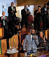 The Rev. William H. Lamar IV, front, leads the Palm Sunday 2024 service at the Metropolitan AME Church in Washington.