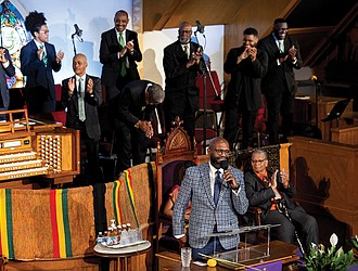 The Rev. William H. Lamar IV, front, leads the Palm Sunday 2024 service at the Metropolitan AME Church in Washington.