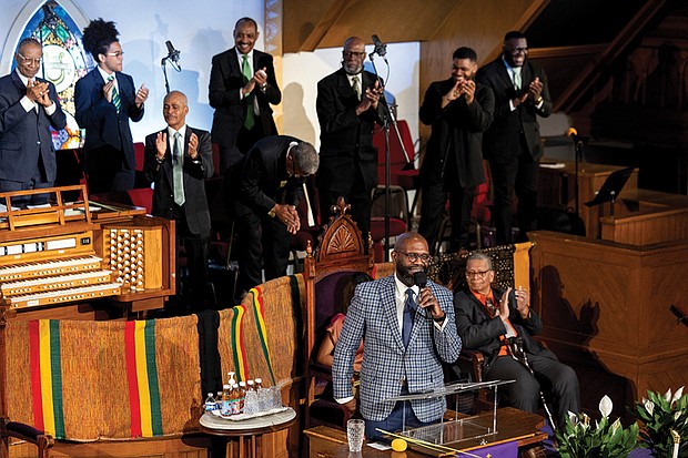 The Rev. William H. Lamar IV, front, leads the Palm Sunday 2024 service at the Metropolitan AME Church in Washington.
