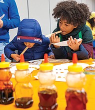 Cousins Kingston Stroia and Liam Marrow, below, sample honey during the Honey Tasting event.