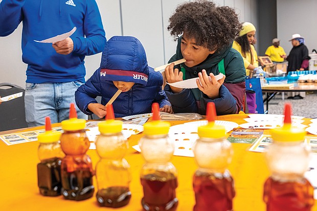 Cousins Kingston Stroia and Liam Marrow, below, sample honey during the Honey Tasting event.