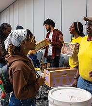 City Bees beekeepers Broson McLeod, Taylor Gayot and Mr. C. discuss the honey harvesting process with attendees.
