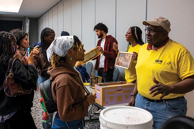 City Bees beekeepers Broson McLeod, Taylor Gayot and Mr. C. discuss the honey harvesting process with attendees.