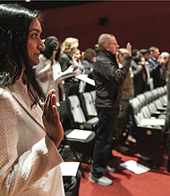 Niharika Patel of India joins dozens of other new U.S. citizens in reciting the Oath of Allegiance during a naturalization ceremony at the Virginia Museum of History & Culture on Presidents Day, Monday, Feb. 17.