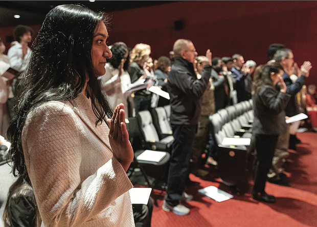 Niharika Patel of India joins dozens of other new U.S. citizens in reciting the Oath of Allegiance during a naturalization ceremony at the Virginia Museum of History & Culture on Presidents Day, Monday, Feb. 17.