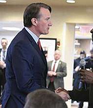 Virginia Military Institute superintendent, Retired Maj. Gen. Cedric Wins, greets Gov. Glenn Youngkin on Dec. 12, 2024.