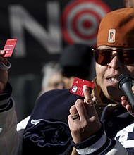 A community advocate cut a Target credit card during a news conference outside Target Corporation's headquarters on January 30, in Minneapolis, Minnesota.
Mandatory Credit:	Ellen Schmidt/AP via CNN Newsource