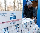 City workers unload cases of emergency drinking water Jan. 7 at Pine Camp Community Center. The site was one of 10 water distribution locations set up after a boil water advisory was issued following a storm-related outage that caused a failure at the water treatment facility.