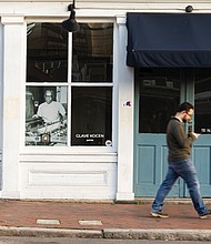 An image of Kirkland Cogbill working at his press circa 1965, is displayed in the window of Glave Kocen Gallery. This was one of 20 large-scale historic photographs featured in windows throughout Shockoe Bottom as part of the public art project “Portals,” which celebrates the lives of Black Richmonders from the early 1800s to the 1980s.