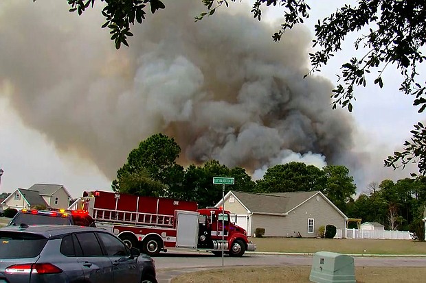 Crews work to contain a fire in the Carolina Forest area west of the coastal resort city of Myrtle Beach, S.C., on March 2, 2025, where residents were ordered to evacuate several neighborhoods.
Mandatory Credit:	WMBF-TV/AP via CNN Newsource