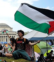 Protestors wave Palestinian flags on the West Lawn of Columbia University in New York on April 29, 2024.
Mandatory Credit:	Timothy A. Clary/AFP/Getty Images/File via CNN Newsource