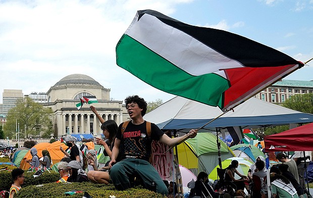 Protestors wave Palestinian flags on the West Lawn of Columbia University in New York on April 29, 2024.
Mandatory Credit:	Timothy A. Clary/AFP/Getty Images/File via CNN Newsource
