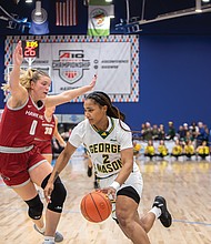 Patriots’ Zahirah Walton (2) maneuvers past Hawks’ Rhian Stokes (1). No. 2 George Mason defeated No. 4 Saint Joseph’s 73-58 in the 2025 Atlantic 10 Women’s Basketball Championship at the Henrico Sports & Events Center on Sunday, March 9.
