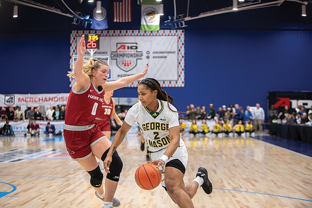 Patriots’ Zahirah Walton (2) maneuvers past Hawks’ Rhian Stokes (1). No. 2 George Mason defeated No. 4 Saint Joseph’s 73-58 in the 2025 Atlantic 10 Women’s Basketball Championship at the Henrico Sports & Events Center on Sunday, March 9.