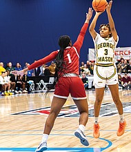 Hawks’ Laura Ziegler (4) grabs a rebound as George Mason’s defenders contest during the 2025 Atlantic 10 Women’s Basketball Championship at the Henrico Sports & Events Center.
