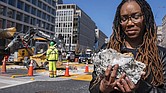 Tears roll down the face of Starlette Thomas, of Bowie, Md., as she holds a chunk of pavement from the Black Lives Matter plaza, Monday, March 10, as the mural begins to be demolished in Washington. “I needed to be here to bear witness,” says Thomas, who was present at the 2020 George Floyd protests.