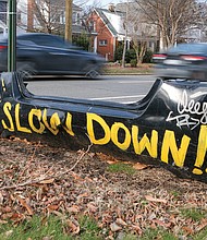 The sentiments of residents in the 2500 block of Semmes Avenue in South Side are captured on a discarded bumper as cars pass by, where the speed limit is 30 mph.