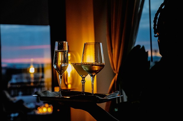 Glasses of wine are served at a rooftop bar.
Mandatory Credit:	Shuran Huang/The Washington Post/Getty Images via CNN Newsource