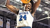 John Marshall’s Latrell Allmond (24) soars for a powerful dunk. The John Marshall Justices defeated the Graham G-Men 107-81 in the Class 2 VHSL State Finals on Thursday, March 13, at the Siegel Center.