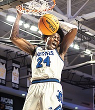 John Marshall’s Latrell Allmond (24) soars for a powerful dunk. The John Marshall Justices defeated the Graham G-Men 107-81 in the Class 2 VHSL State Finals on Thursday, March 13, at the Siegel Center.