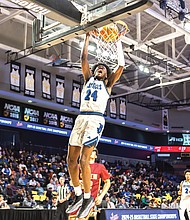 Latrell Allmond (24) of John Marshall raises up for a score in the Justices’ 107-81 victory March 13 over the Graham G-Men in the Class 2 VHSL State Finals at the Siegel Center.