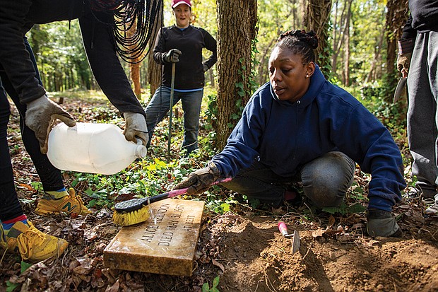 A volunteer works at East End Cemetery in Henrico County alongside groups from the National Park Service, Virginia Commonwealth University and the University of Richmond in 2019.