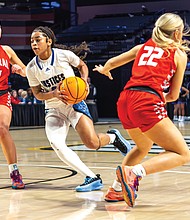 John Marshall’s Yasmin Hall (3) maneuvers around Central’s Abbie Jordan (14) during the Class 2 VHSL State Finals on Thursday, March 13, 2025. The Central Wise Warriors defeated the John Marshall Justices 75-45.