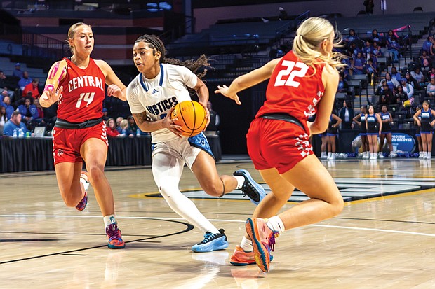 John Marshall’s Yasmin Hall (3) maneuvers around Central’s Abbie Jordan (14) during the Class 2 VHSL State Finals on Thursday, March 13, 2025. The Central Wise Warriors defeated the John Marshall Justices 75-45.
